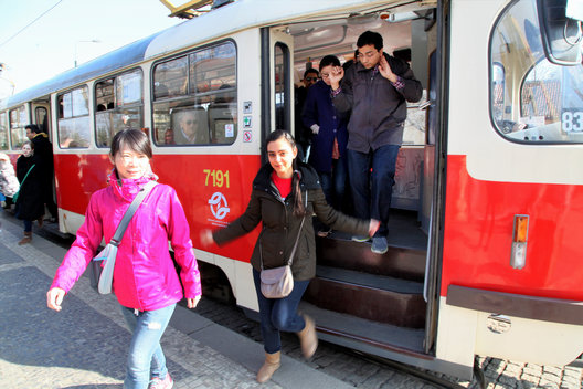 Study-trip participants getting off a tram during a cultural visit