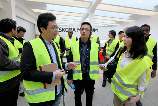 Students in high-visibility vests visiting a company